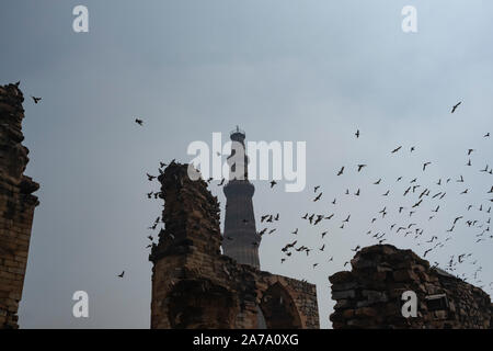 View of Qutub Minar againt the screen arches. Stock Photo