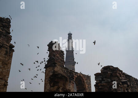 View of Qutub Minar againt the screen arches. Stock Photo