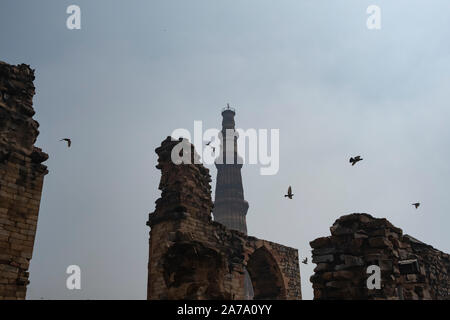 View of Qutub Minar againt the screen arches. Stock Photo