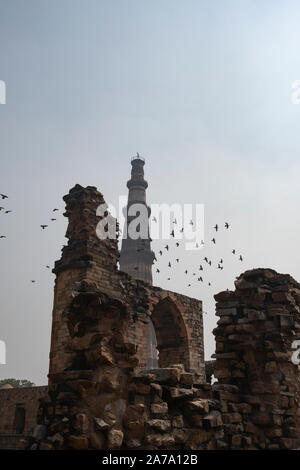 View of Qutub Minar againt the screen arches. Stock Photo