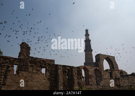 View of Qutub Minar againt the screen arches. Stock Photo