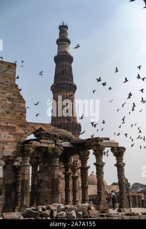 View of Qutub Minar againt the screen arches. Stock Photo