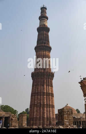 View of Qutub Minar againt the screen arches. Stock Photo