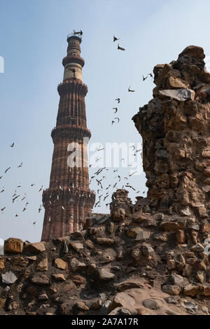 View of Qutub Minar againt the screen arches. Stock Photo