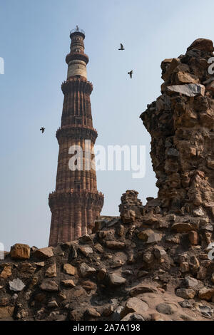 View of Qutub Minar againt the screen arches. Stock Photo