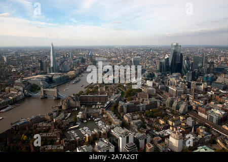 An aerial view of the City of London with Tower Bridge and St Katherines Dock in the foreground.
