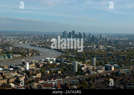 The Canary Wharf Financial District and the River Thames seen from the air across South London.