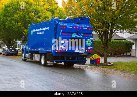 Back of a Blue Recycling Truck on a Residential Street in the Lower Mainland, British Columbia, Canada. Stock Photo