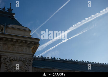 Condensation Trails over a classical building in Bucharest, Romania. Stock Photo