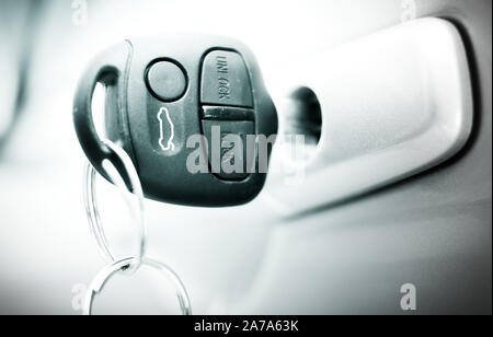 Black-and-white photo of a car key in the door. Stock Photo