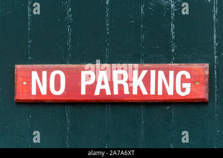 No Parking sign in red and white across a garage door, UK Stock Photo