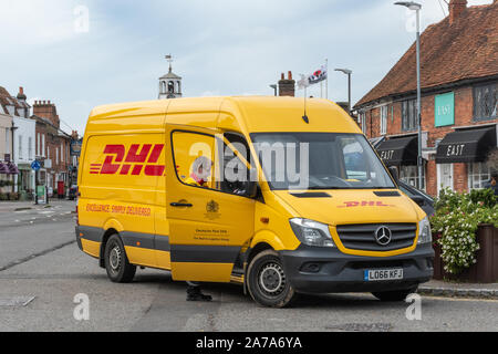 DHL delivery van and driver on the high street in Amersham Old Town, Buckinghamshire, UK Stock Photo