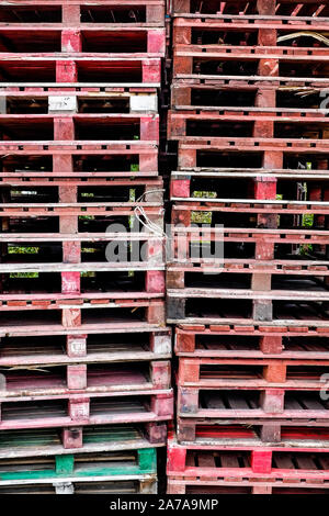 A high stack of wooden pallets. Stock Photo