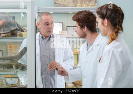 teacher and students experimenting with animals Stock Photo