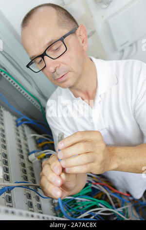 network engineer working in server room Stock Photo