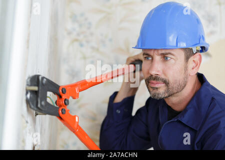 a worker uses scissors indoors Stock Photo