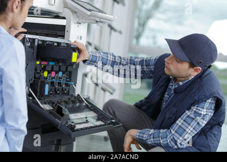 worker preparing print screening metal machine Stock Photo