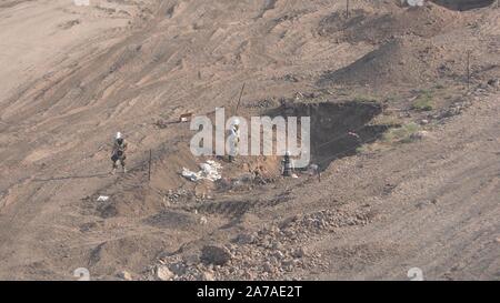 Enginers of 4M defense with protective gear inspecting an old Syrian minefield just before clearing the mines on Gofra beach in the sea of Galilee, Israel Stock Photo