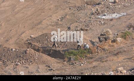 Enginers of 4M defense with protective gear inspecting an old Syrian minefield just before clearing the mines on Gofra beach in the sea of Galilee, Israel Stock Photo