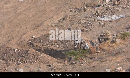 Enginers of 4M defense with protective gear inspecting an old Syrian minefield just before clearing the mines on Gofra beach in the sea of Galilee, Israel Stock Photo