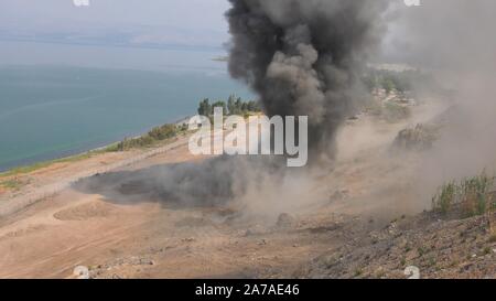 Enginers of 4M defense with protective gear inspecting an old Syrian minefield just before clearing the mines on Gofra beach in the sea of Galilee, Israel Stock Photo