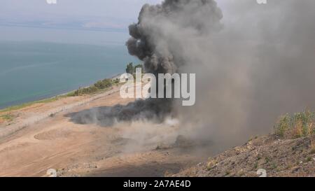 Enginers of 4M defense with protective gear inspecting an old Syrian minefield just before clearing the mines on Gofra beach in the sea of Galilee, Israel Stock Photo