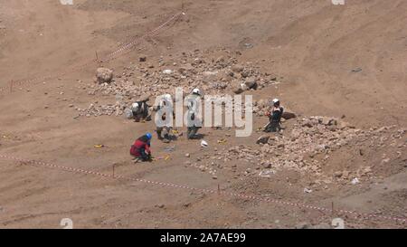 Enginers of 4M defense with protective gear attach explosives to mines in old Syrian minefield just before clearing the mines on Gofra beach in the sea of Galilee, Israel Stock Photo