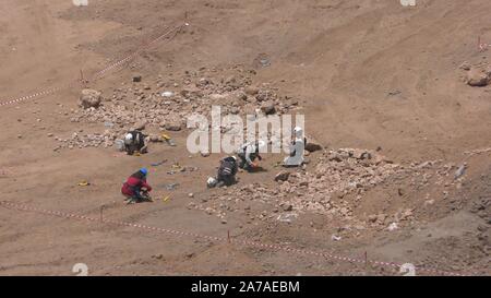 Enginers of 4M defense with protective gear attach explosives to mines in old Syrian minefield just before clearing the mines on Gofra beach in the sea of Galilee, Israel Stock Photo