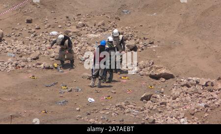 Enginers of 4M defense with protective gear attach explosives to mines in old Syrian minefield just before clearing the mines on Gofra beach in the sea of Galilee, Israel Stock Photo