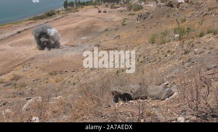 Enginers of 4M defense with protective gear inspecting an old Syrian minefield just before clearing the mines on Gofra beach in the sea of Galilee, Israel Stock Photo