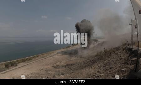 Enginers of 4M defense with protective gear inspecting an old Syrian minefield just before clearing the mines on Gofra beach in the sea of Galilee, Israel Stock Photo