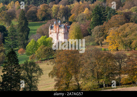 The Pink Colour of Craigievar Castle Complements the Autumnal Colours of the Various Trees on a Wooded Hillside in Aberdeenshire. Stock Photo