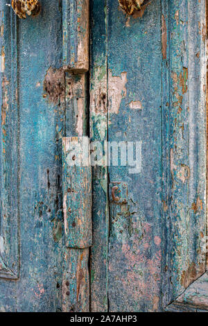 Fragment of an old blue wooden door with shabby paint Stock Photo