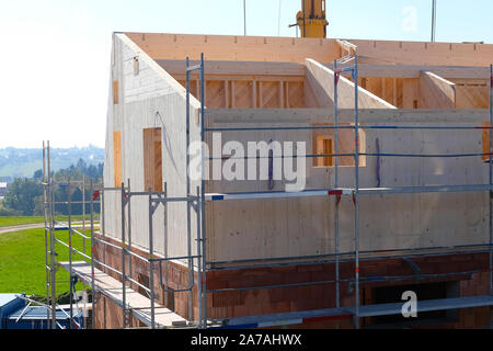 Framehouse with solid wooden walls is being built on bricks Stock Photo