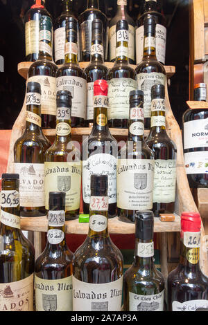 Bottles of aged Calvados Brandy in shop window, Place de Catherine, Honfleur, Normandy, France Stock Photo