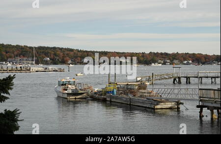 Boothbay, ME / USA - October 20, 2019: Harbor holding fishing boats with lobster traps and crab cages Stock Photo