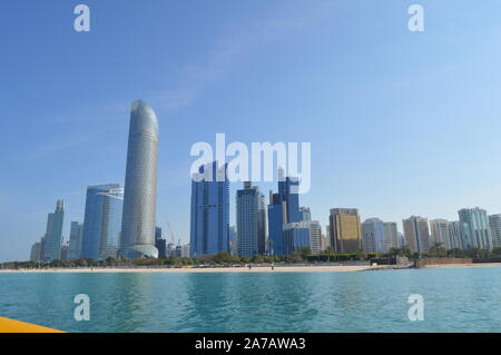 Abu Dhabi city skyline and skyscrapers along Corniche beach taken from a boat in UAE , United Arab Emirates Stock Photo