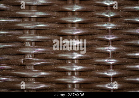 Closeup of brown woven plastic pattern background. Stock Photo