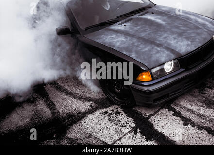 Moldova 25.09.2019. Sport modern Stance Car racing car drifting with smoke drift burnout, big colourful green blue clouds with clean wheels and burnin Stock Photo