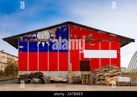 Close-up of the national flag of Taiwan  painted on the metal wall of a large warehouse the closed territory on a summer day. The concept of storage o Stock Photo
