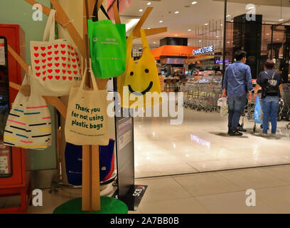 Bangkok, Thailand - October 31 2019 : Many cloth bags hanging on hanger standing in Siam Paragon shopping mall as campaign for not using  plastic bags Stock Photo