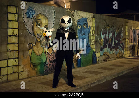 Malaga, Spain. 31st Oct, 2019. A man dressed up as Jack Skellington poses for a photo during the VI edition of 'Churriana Noche del Terror' (Churriana Horror Night) to celebrate the Halloween night in the neighbourhood of Churriana.Residents of Churriana participate in the Halloween day dressed with horrific costumes, decorating their houses and with scary performances along the streets. The 'Churriana Horror Night' is one the most popular event in the city to marks the Halloween Day, and for this occasion the theme of the edition is the witches. Credit: SOPA Images Limited/Alamy Live News Stock Photo