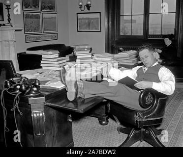1/26/1938 - Democrat Senator Allen J. Ellender, of Louisiana, rests and studies up on Senate procedure of filibuster while his colleagues continue the Filibuster against the anti-lynching bill ca. 1938 Stock Photo