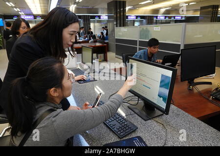 Suzhou, China's Jiangsu Province. 31st Oct, 2019. Staff members work at the administrative service center in Taicang, east China's Jiangsu Province, Oct. 31, 2019. Taicang has been making great efforts to improve business environment through facilitating administrative procedures for enterprises including registration, project approval and tax registration in recent years. As a result, Taicang has built economy and trade relations with over 160 countries and regions and attracted investment of over 1,500 foreign enterprises. Credit: Ding Hongfa/Xinhua/Alamy Live News Stock Photo