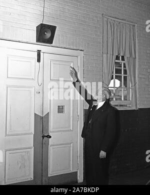 Man pointing to a speaker system ca. 1935 Stock Photo