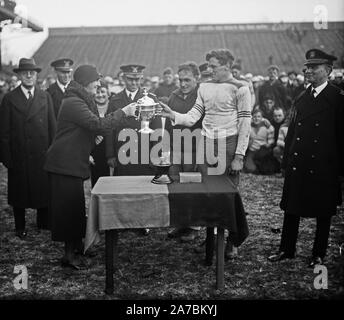 Trophy cup at football game (Army-Navy game?) ca. 1931 Stock Photo