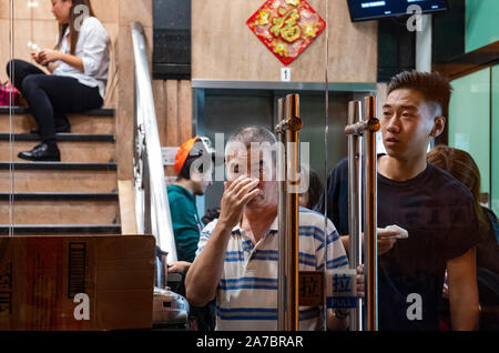 Hong Kong, China. 31st Oct, 2019. Commuters and residents take cover after police has fired tear gas. Protesters at Halloween march in Hong Kong island despite police banned rallies and confront them during the night. Credit: SOPA Images Limited/Alamy Live News Stock Photo