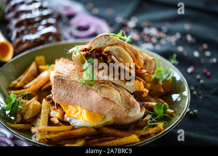 tasty ribs sandwich with french fries and fresh vegetables Stock Photo