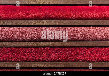 samples of multi-colored carpets on the shelves Stock Photo