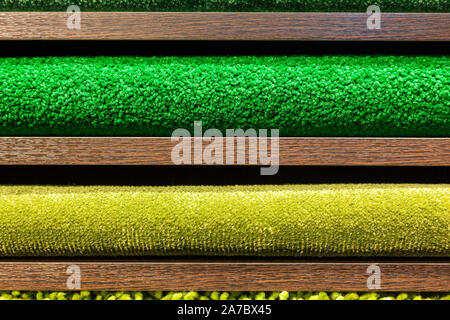 samples of multi-colored carpets on the shelves Stock Photo